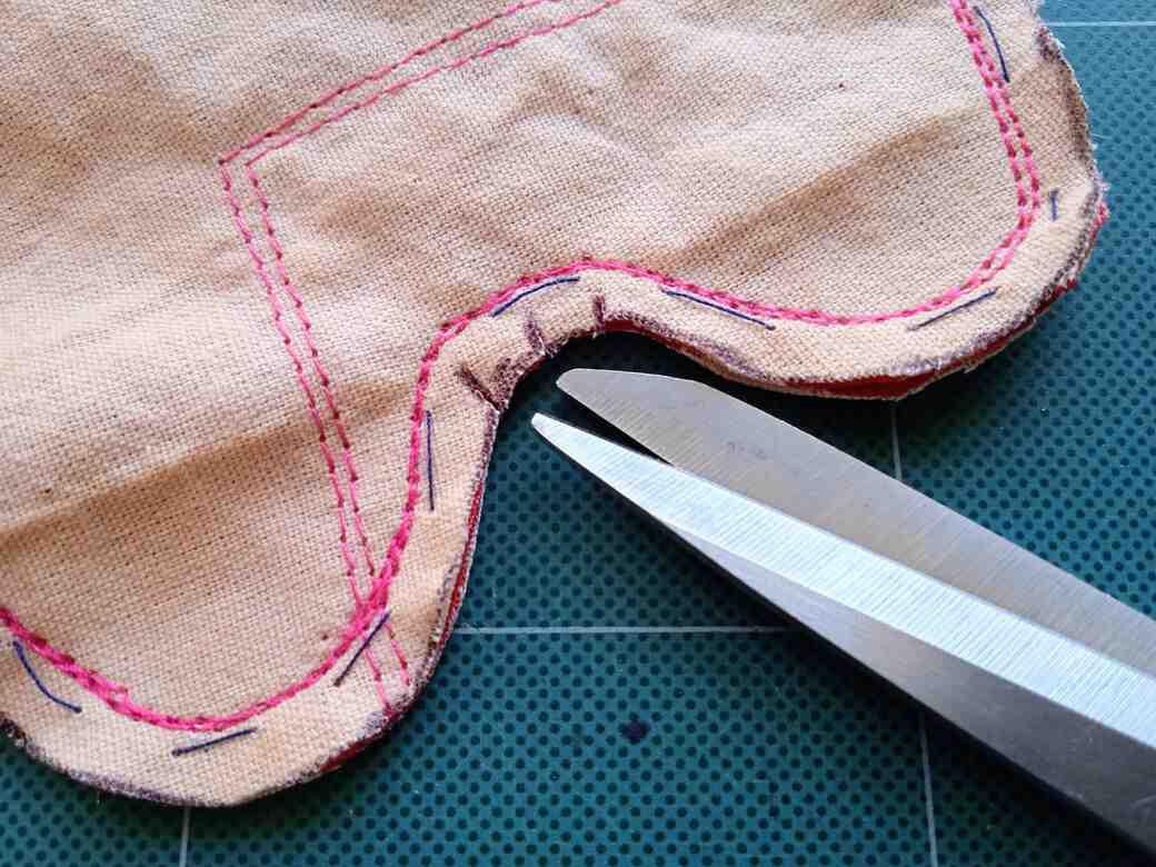 carefully snip (clip) curved seam between legs.