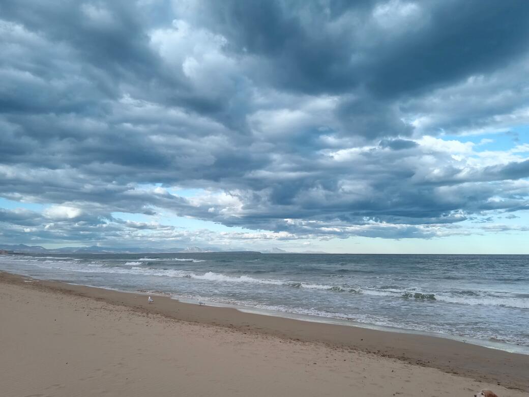 Deserted beach as clouds gather and a storm rolls in.