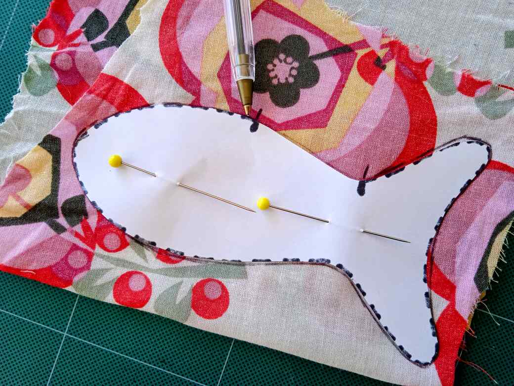 Pin the paper pattern to the fabric.