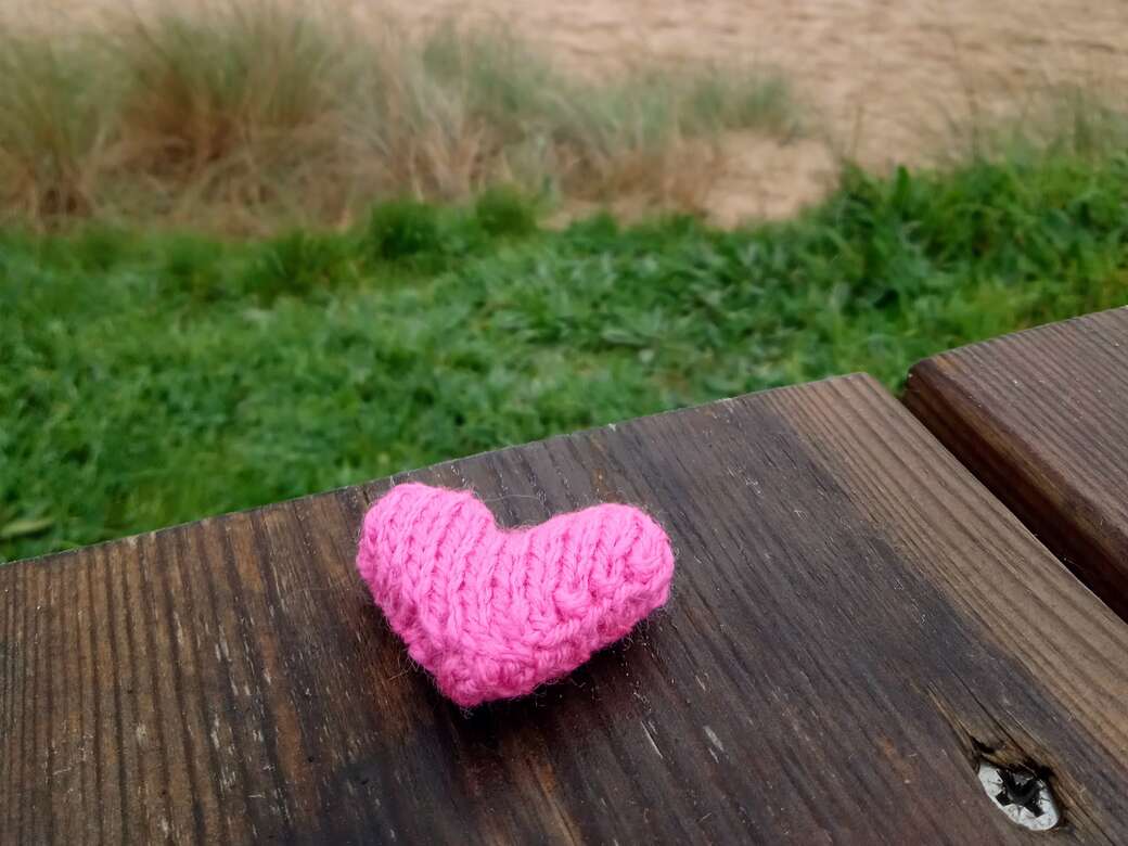 Knitted heart on bench