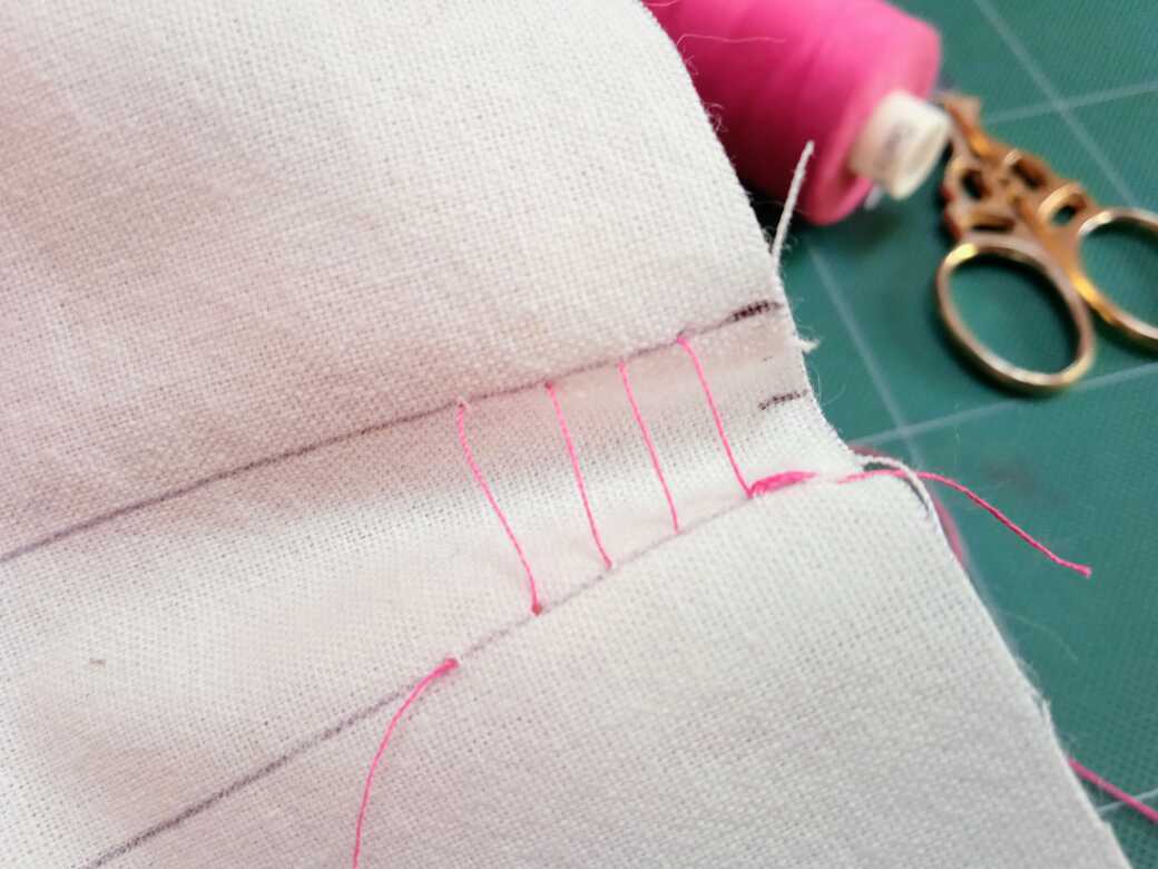 How to sew ladder stitch - Step 4: Continue to make alternate stitches and start to tighten the thread to pull together the top and bottom lines.