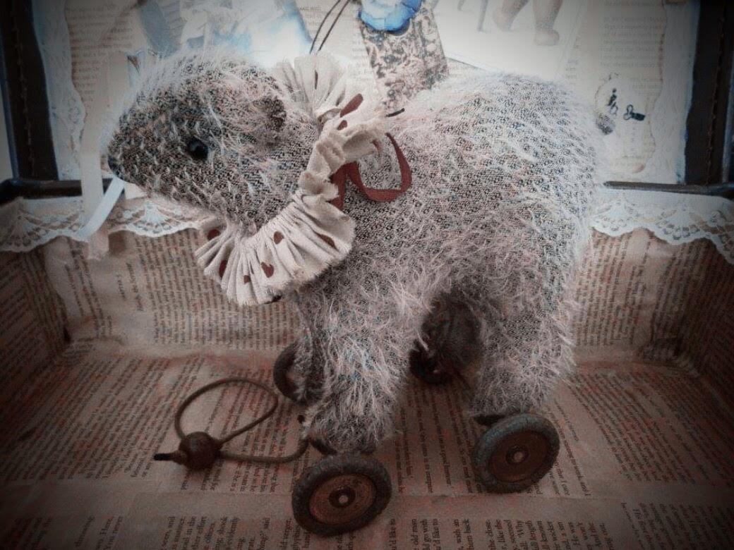 Little vintage style bear on wheels.