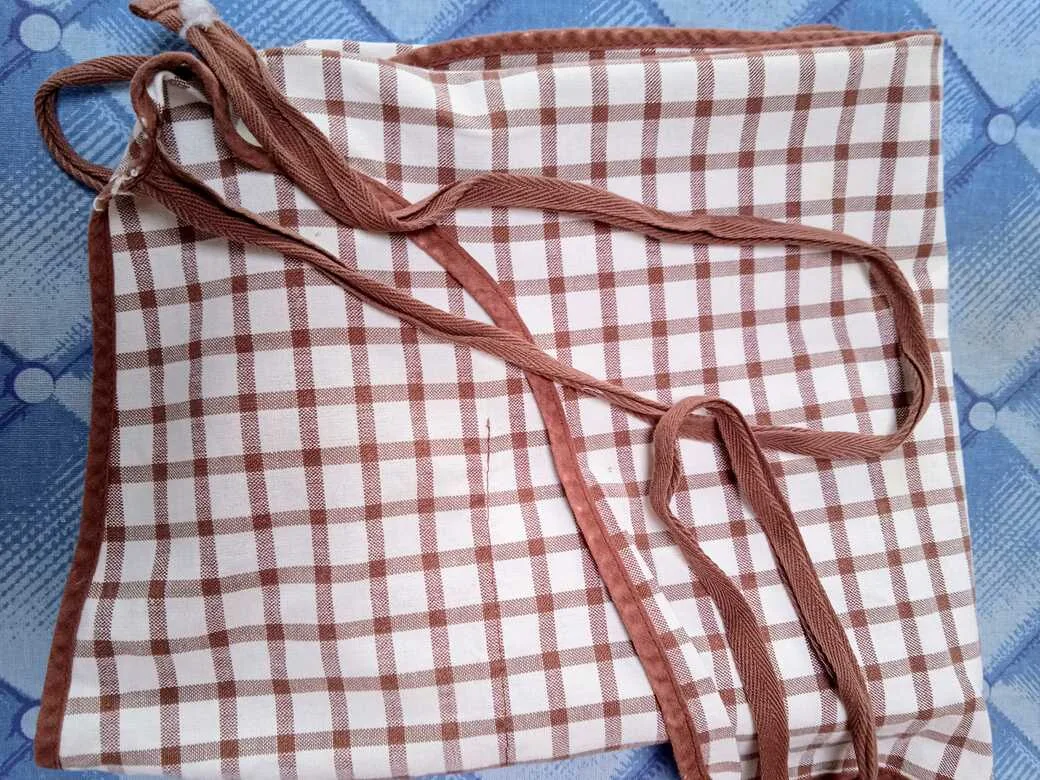 Old apron, a bit tatty and worn. Recyclable fabrics.