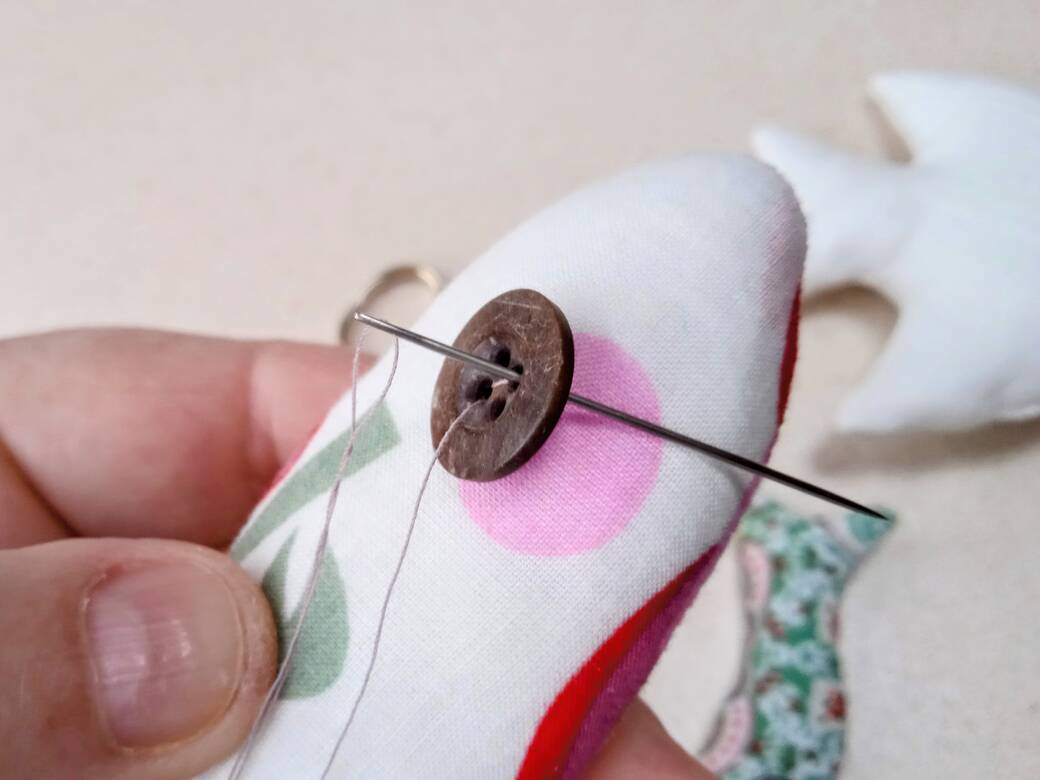 Sew on a button, step 5.