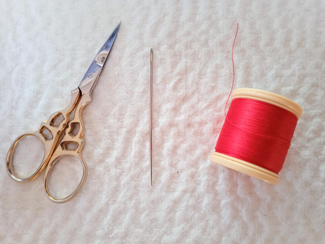 Scissors, needle and thread.