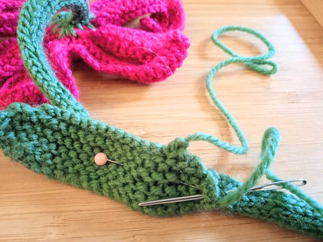 Wall Flower, knitted flower, attach first leaf step 2.