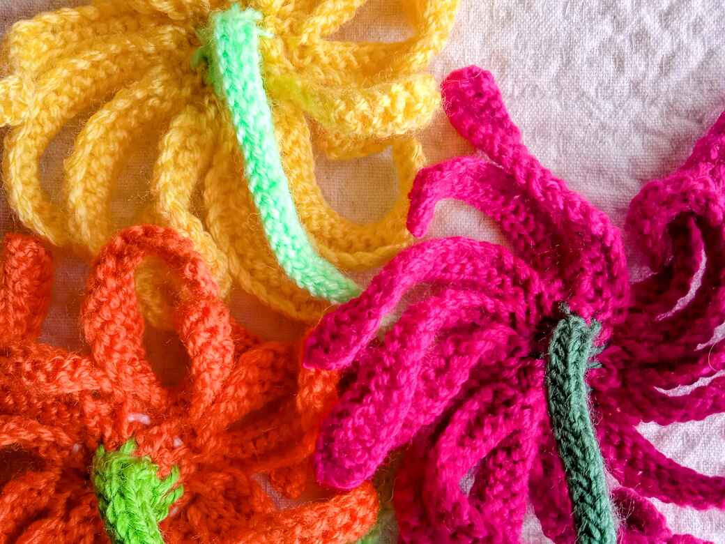 Wall Flowers, knitted flowers, receptacles.