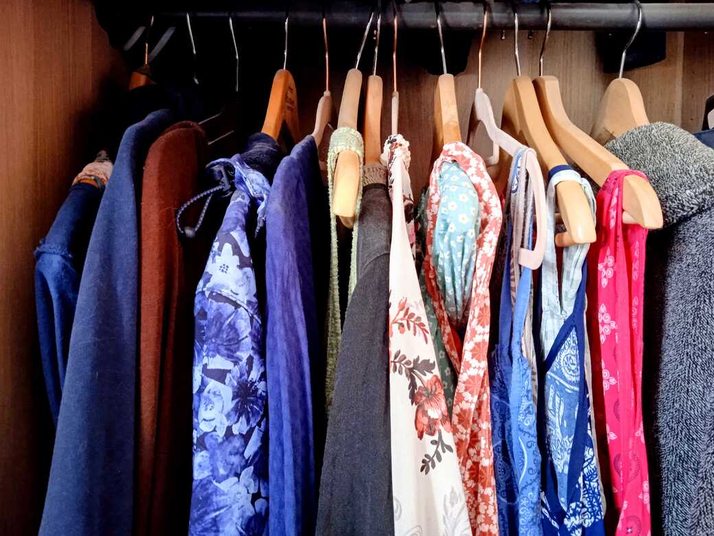 Wardrobe full of clothes.